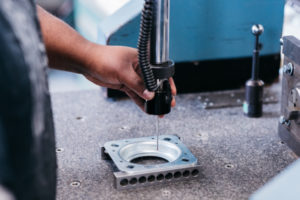 CMM inspection machine probe being used to measure stamped metal components at Lutco